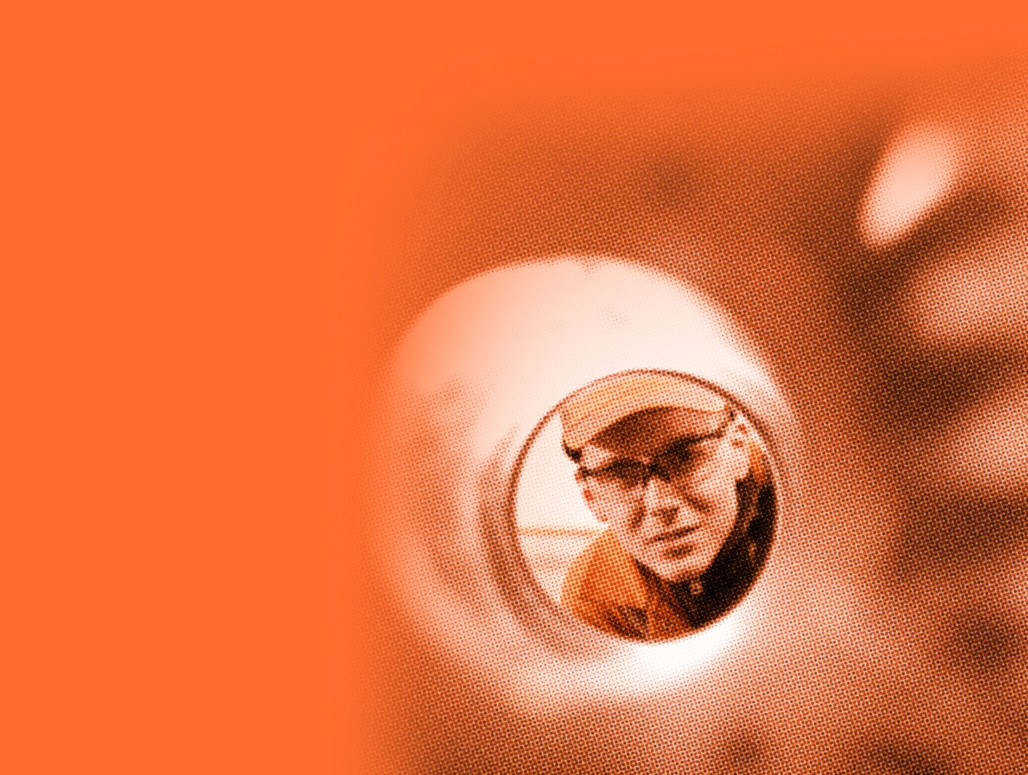 Man with safety glasses looks at camera through large tube