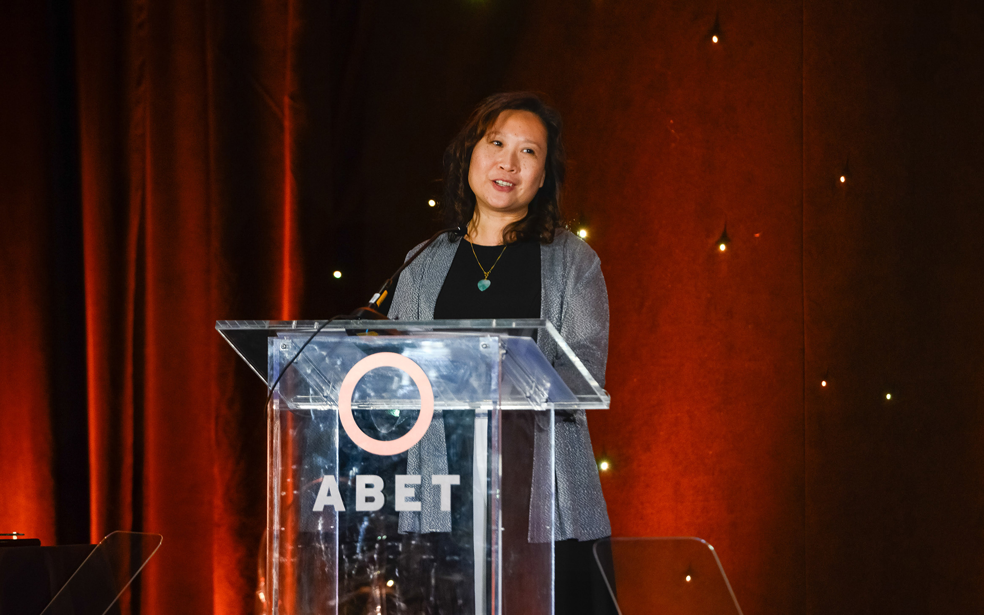 Woman stands at podium delivering speech at ABET Awards